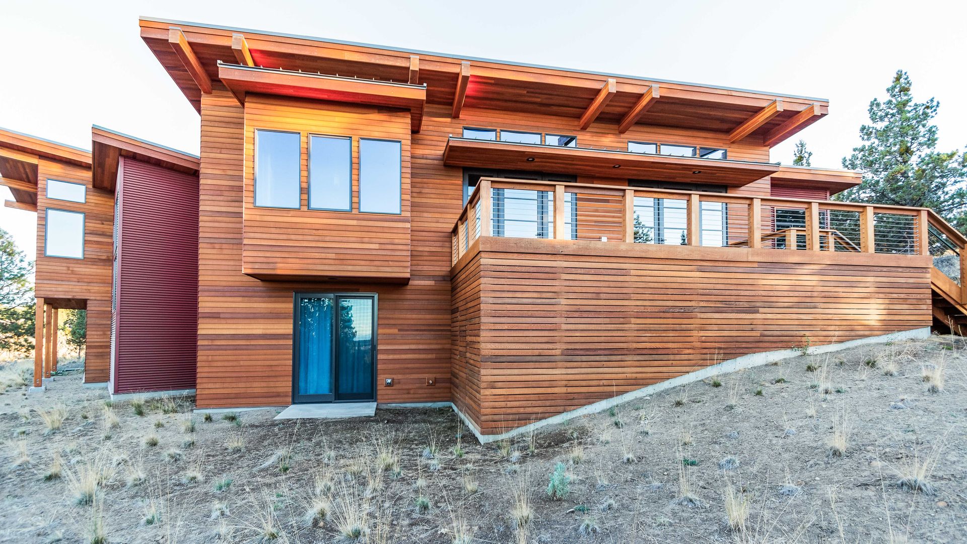 a large wooden house is sitting on top of a hill .
