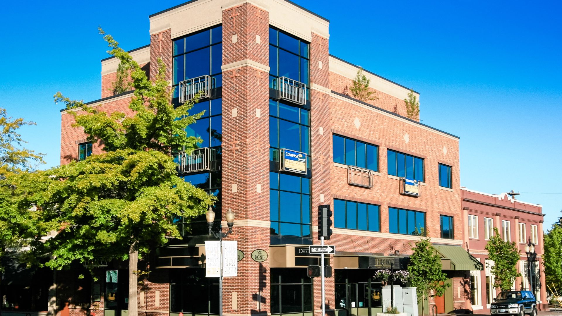 a large brick building with a lot of windows on a sunny day .