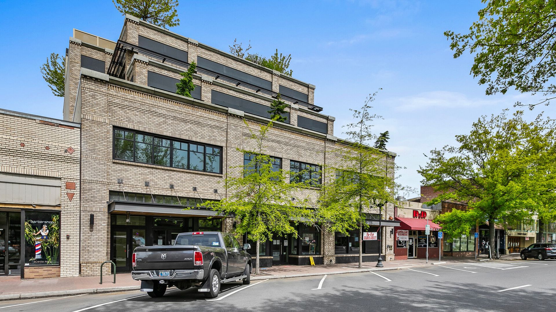 a truck is parked in front of a large brick building .