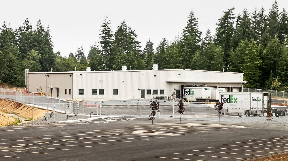 a fedex truck is parked in front of a building