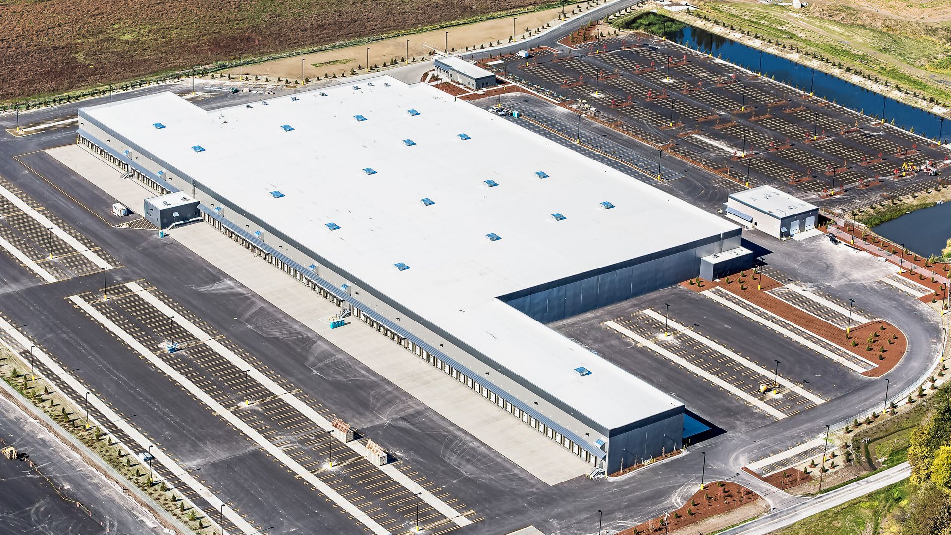 an aerial view of a large building with a white roof