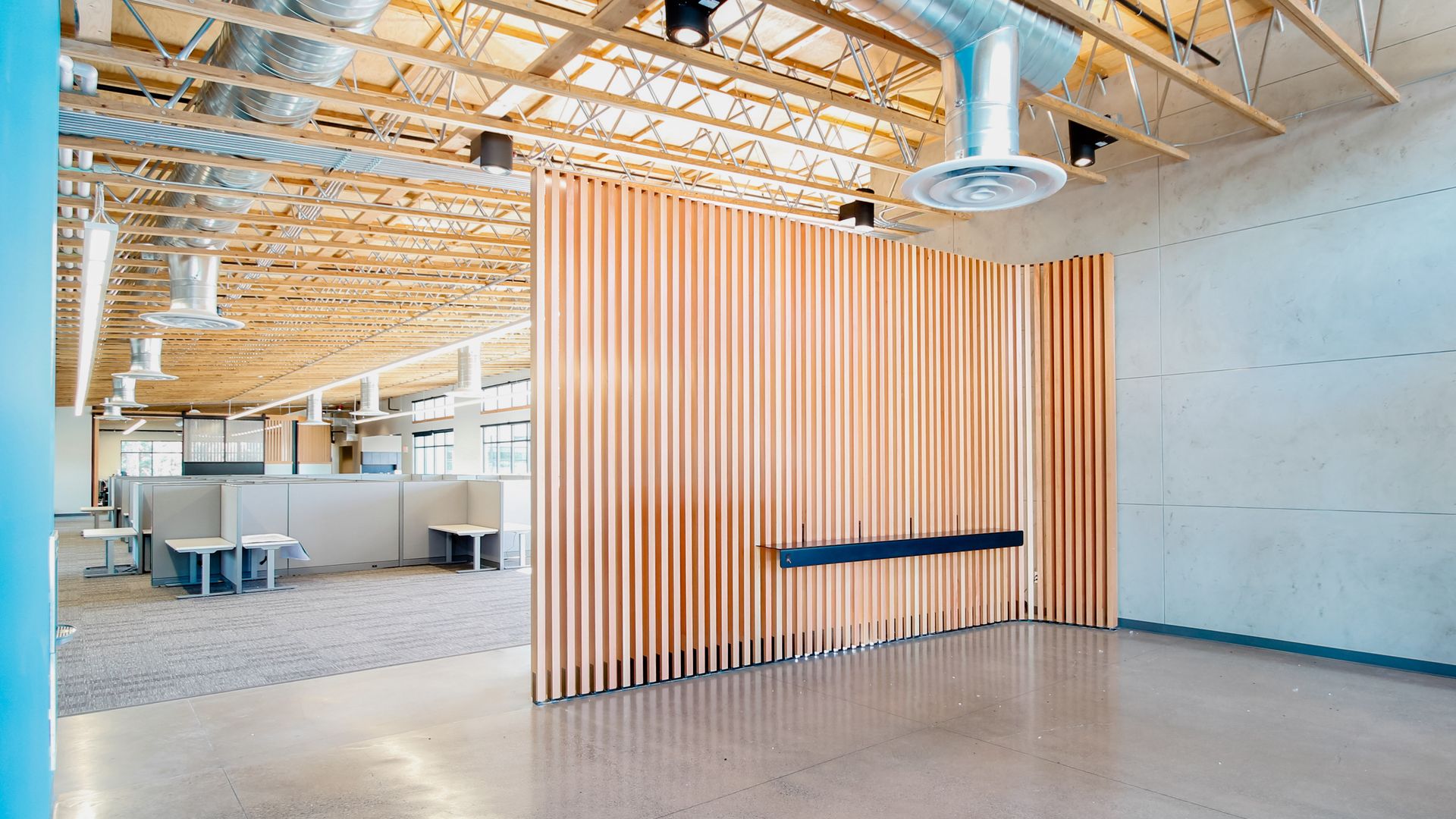 a large office building with a lot of windows and cubicles .