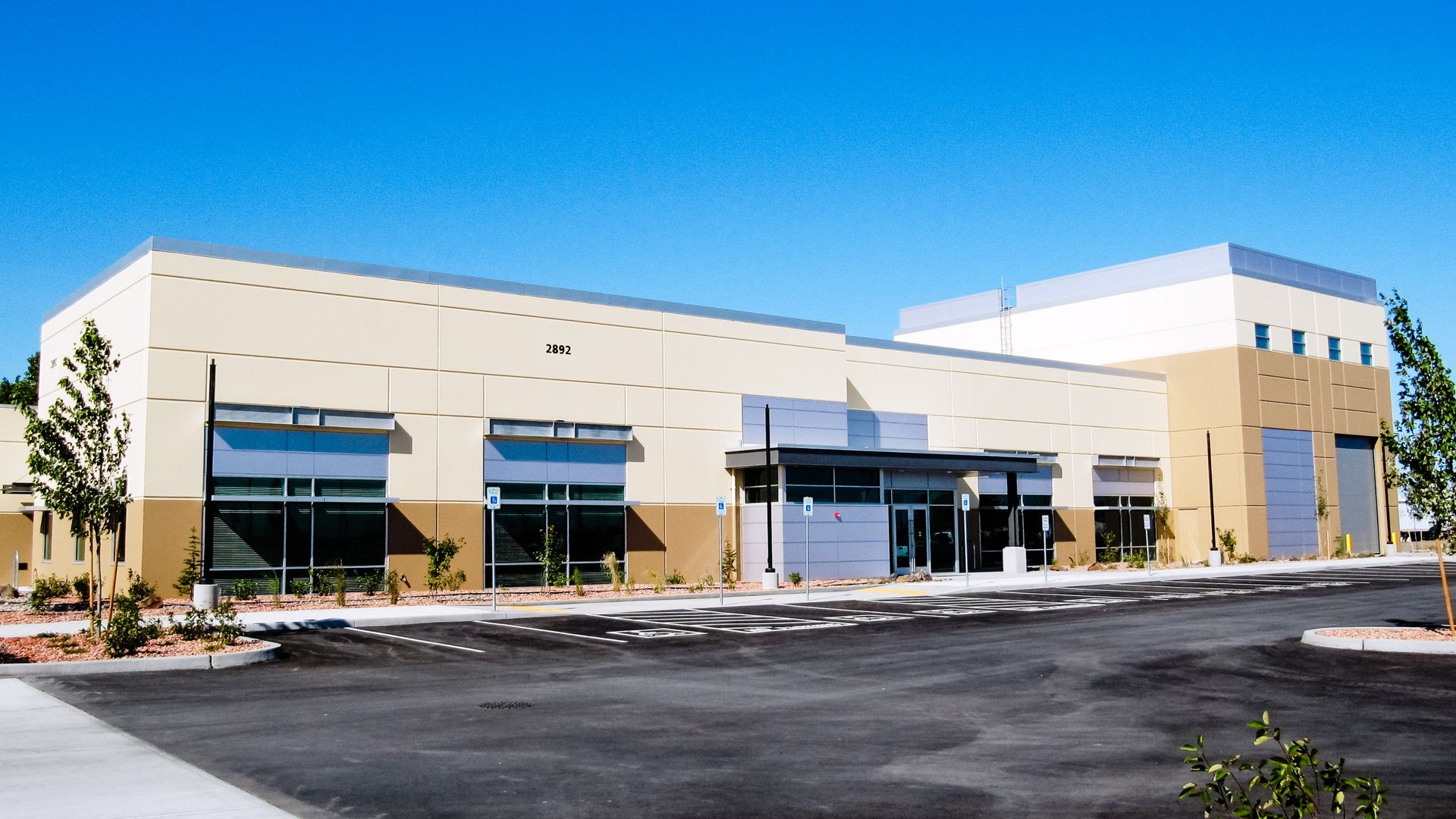 a large building with a parking lot in front of it