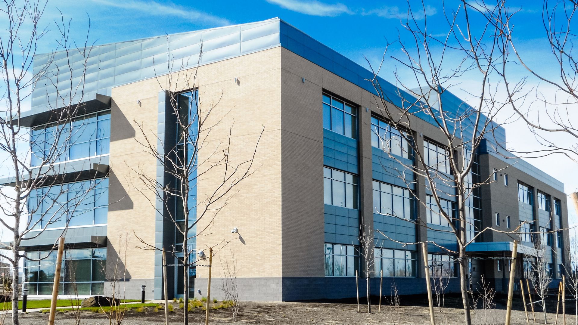 a large building with a lot of windows and trees in front of it .
