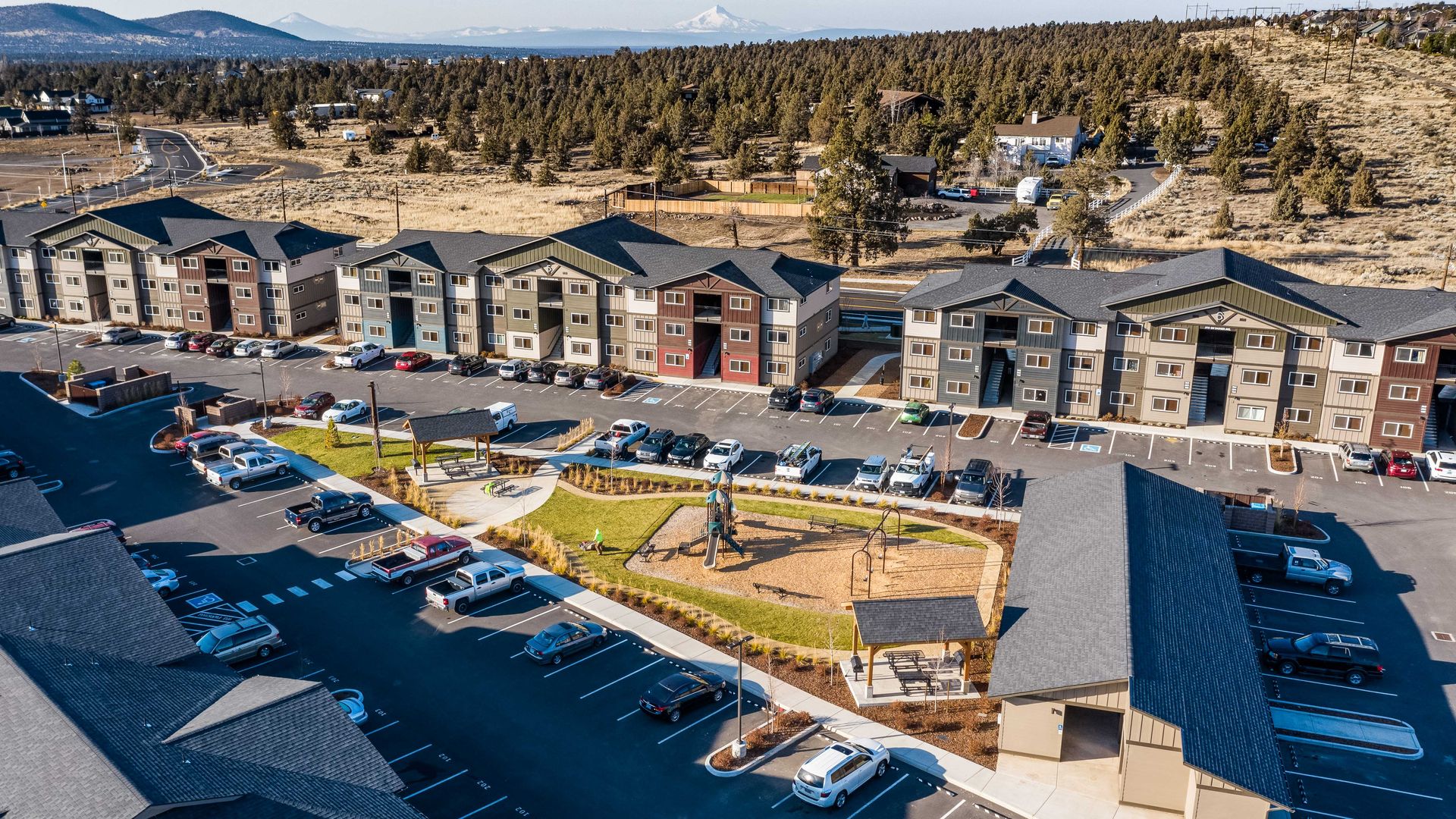 an aerial view of a row of houses and a parking lot .