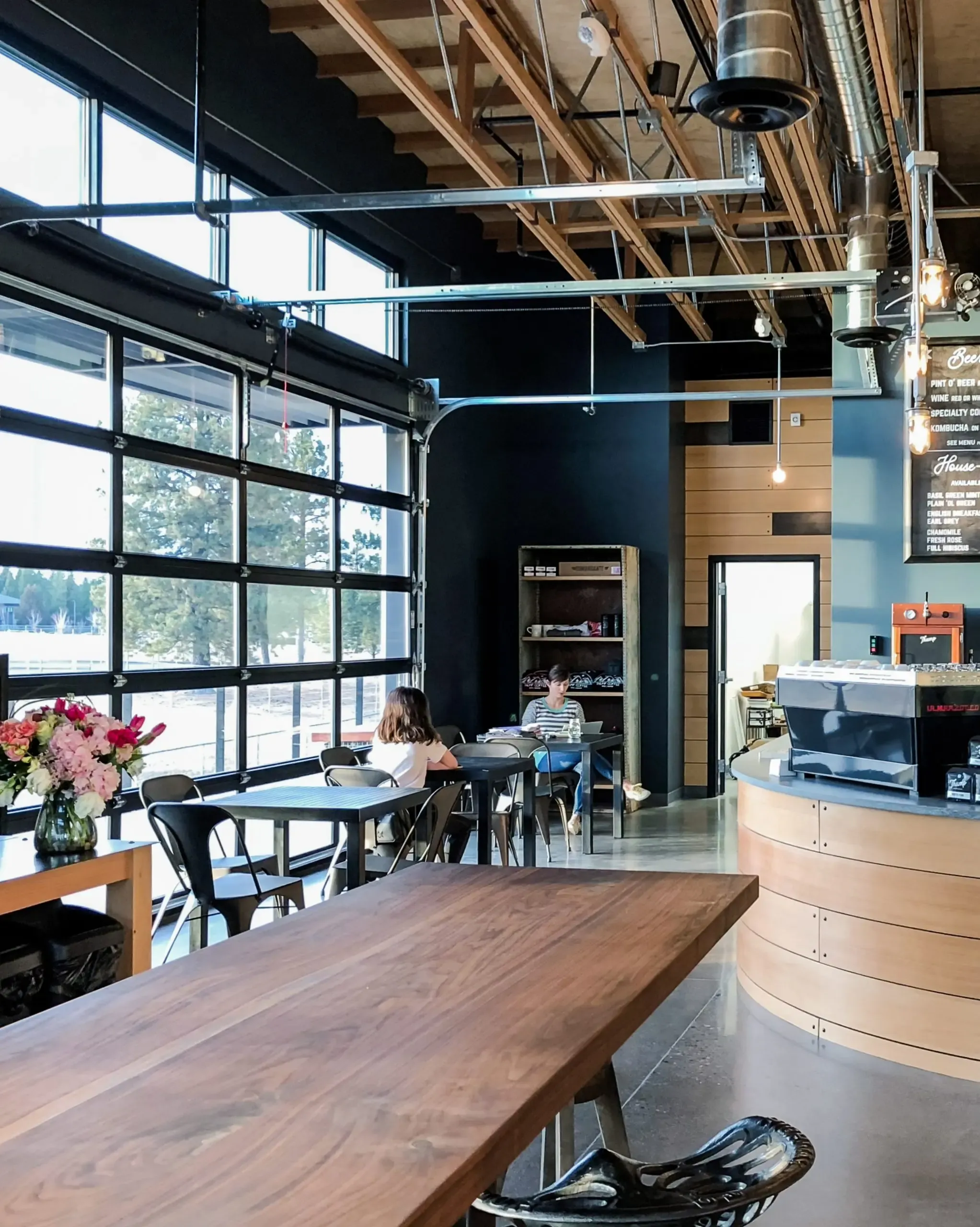 a restaurant with tables and chairs and a large window