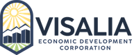 Logo of Visalia Economic Development Corporation: sun, mountains, and buildings in a blue arched frame; text