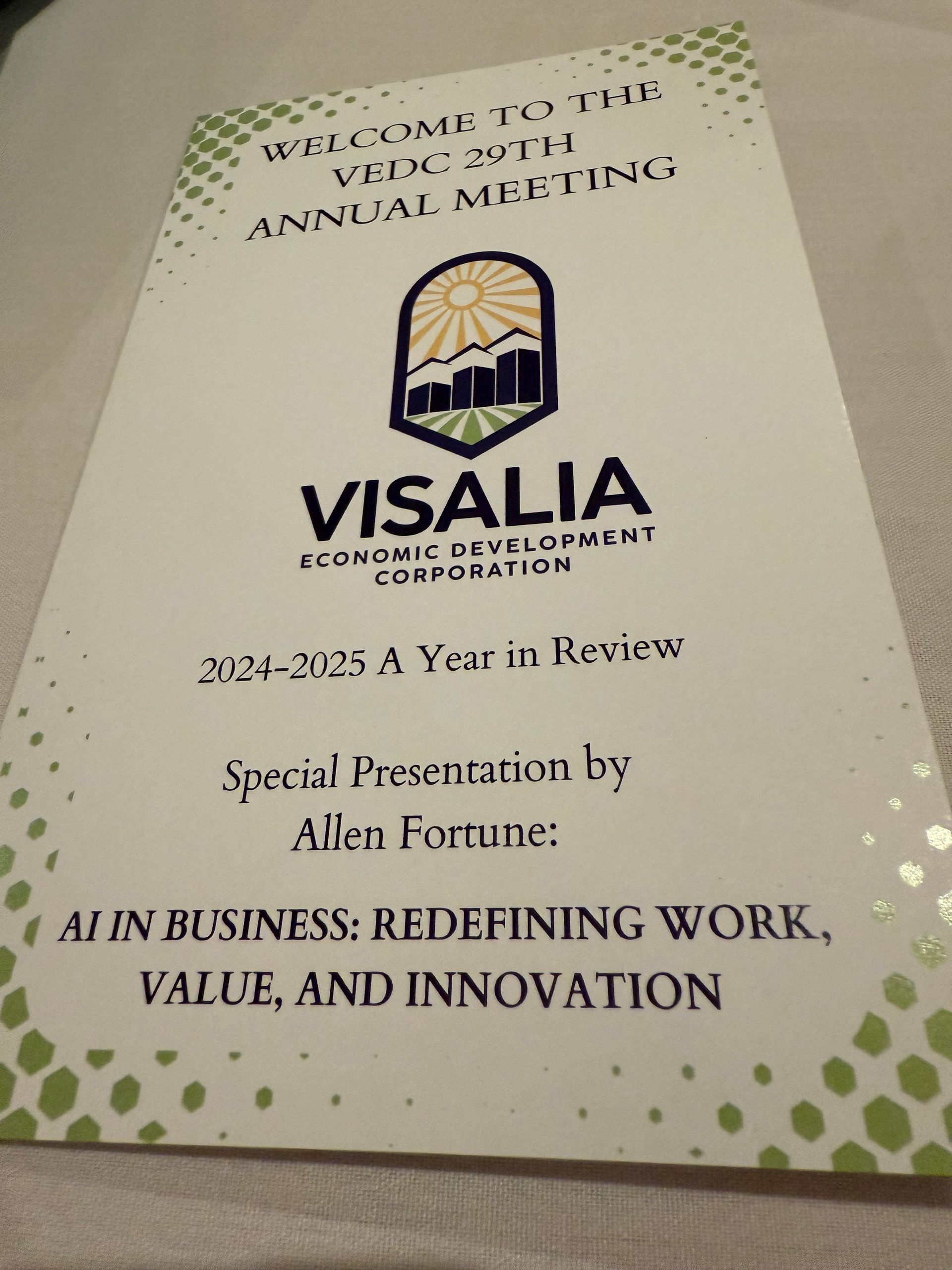 White card for Visalia Economic Development Corp annual meeting, with logo and presentation details.