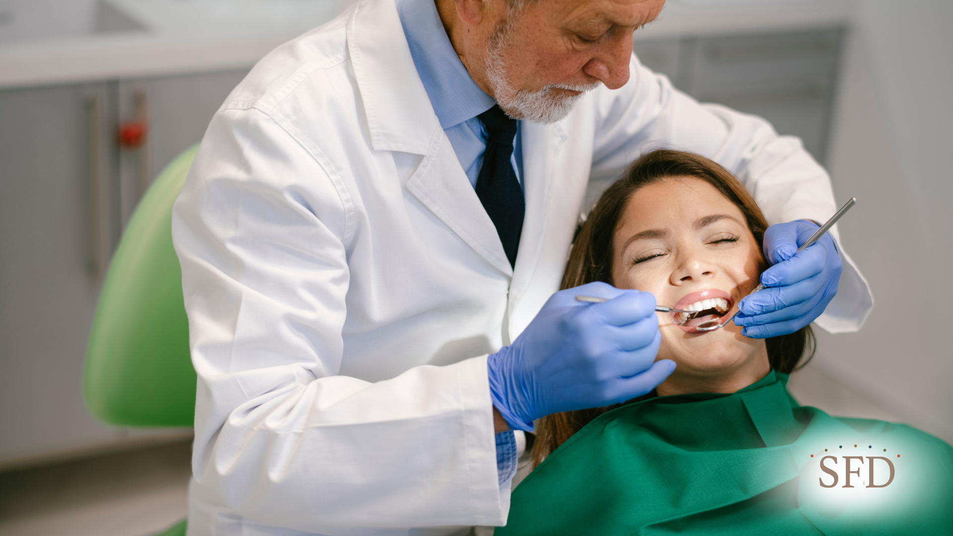Dentist examining a young woman's teeth in a dental clinic.