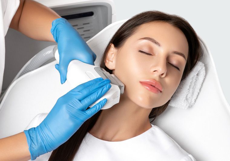 Woman With a Towel Wrapped Around Her Head is Getting a Facial Treatment — Advanced Cosmetic & Beauty Clinic in Bundaberg South, QLD
