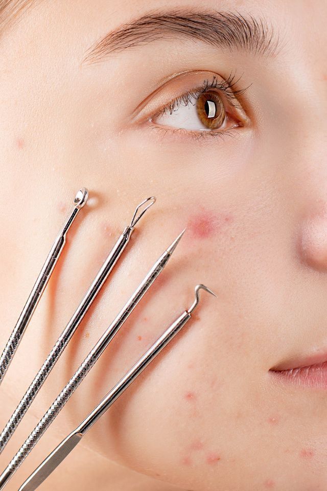 Woman is Looking at Her Face in the Mirror — Advanced Cosmetic & Beauty Clinic in Bundaberg South, QLD