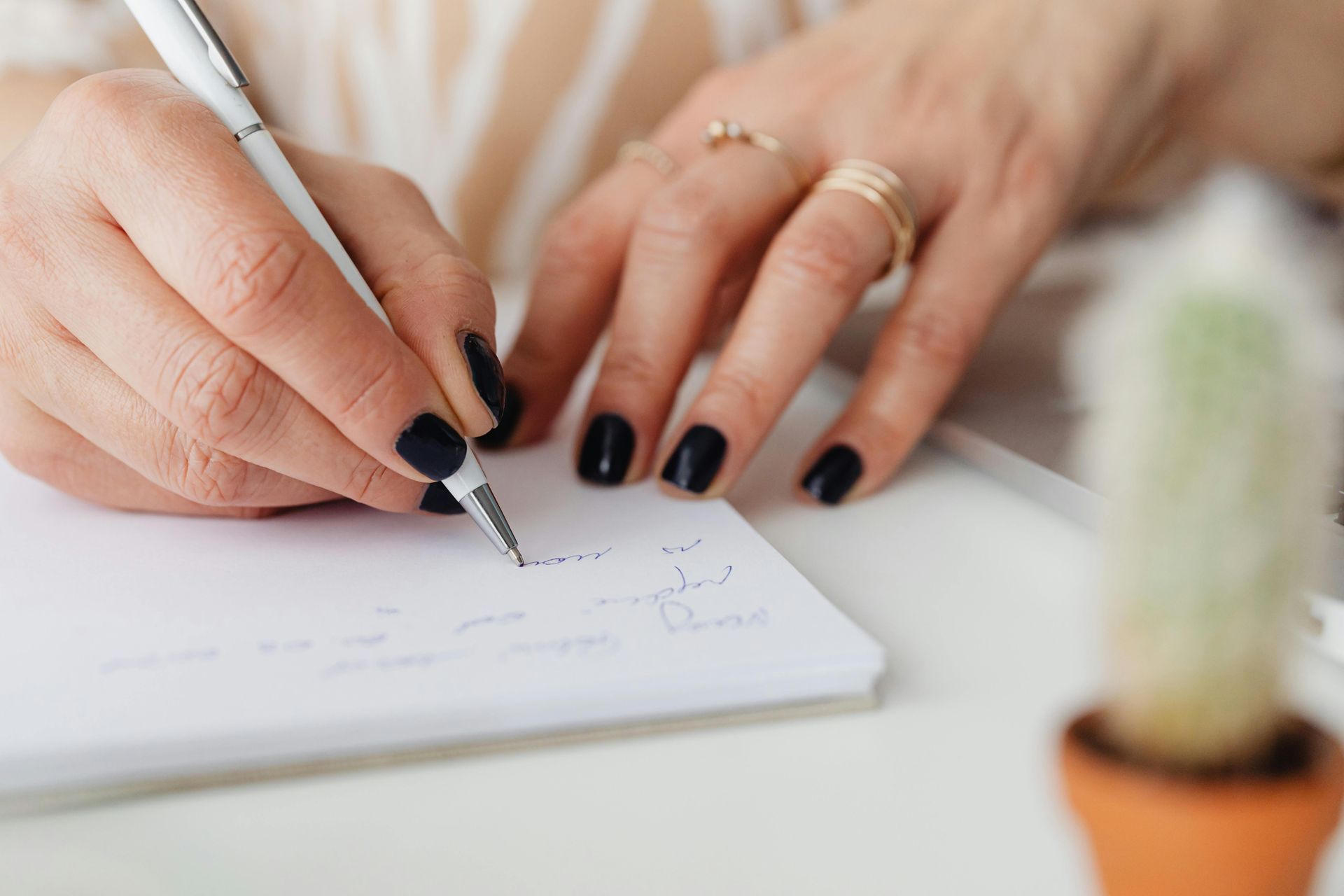 Image of someone writing down a note in therapy