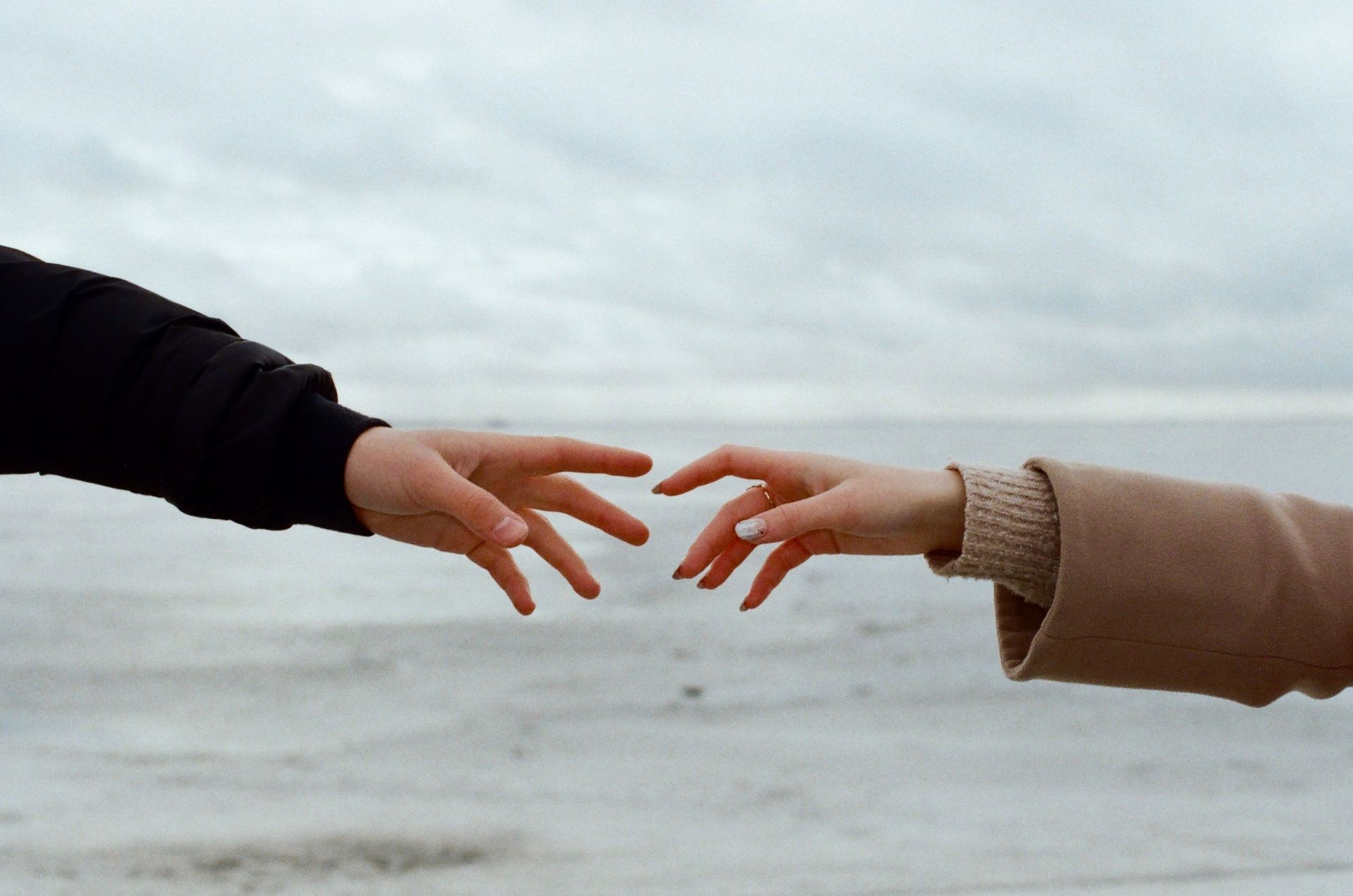 Two hands reaching out to one another