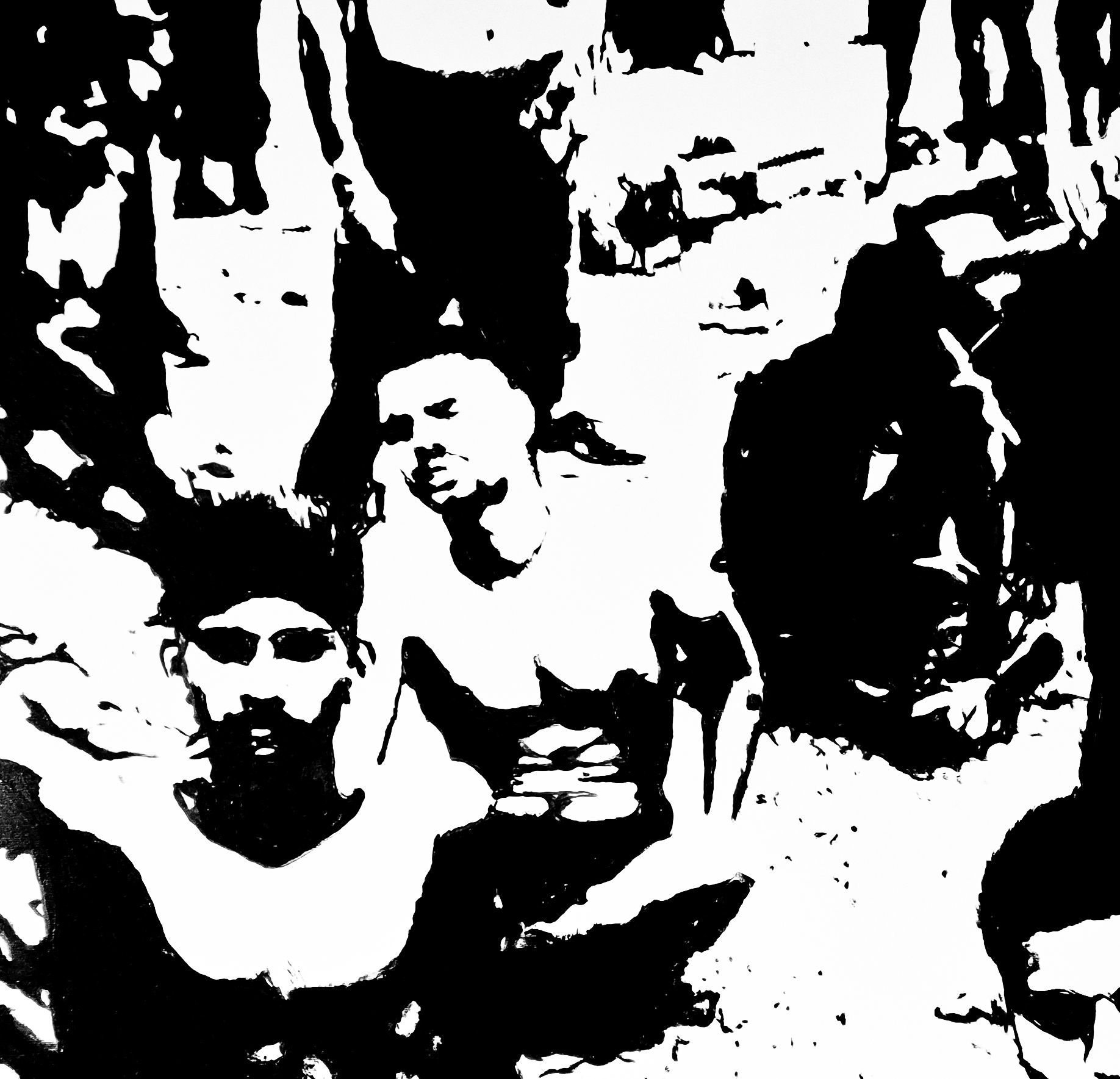 Group of people in a monochrome photo. Two men in the center are the most visible; others blend into black and white.