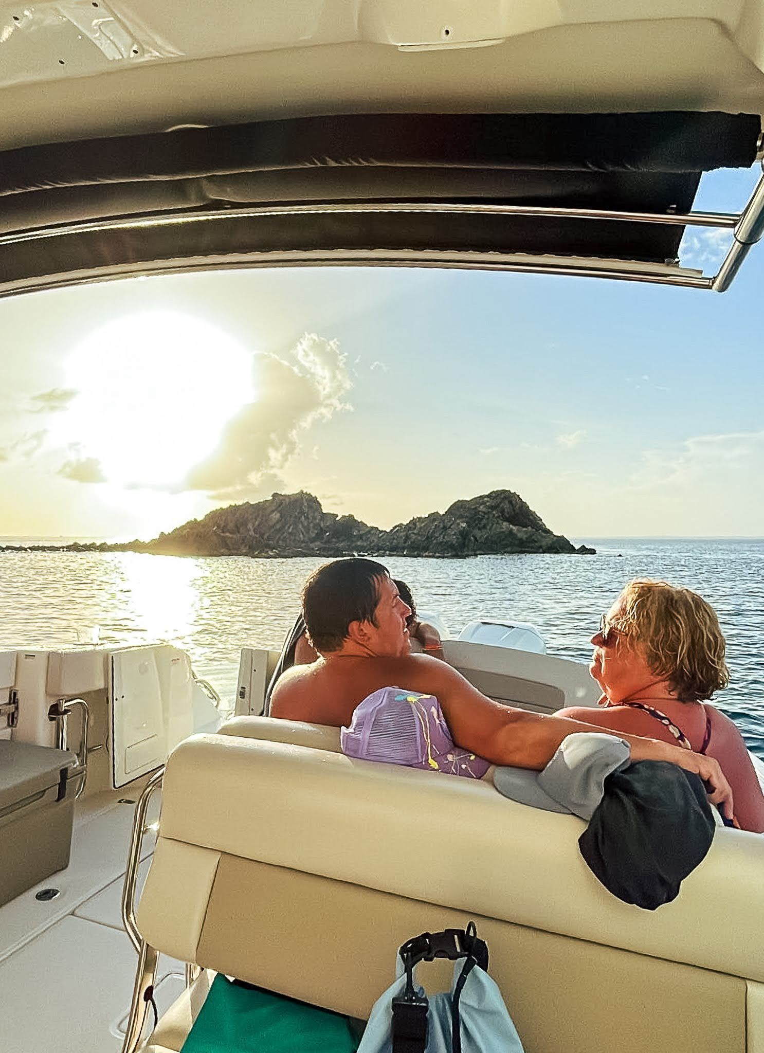 A man and a woman are sitting on a boat in the ocean.