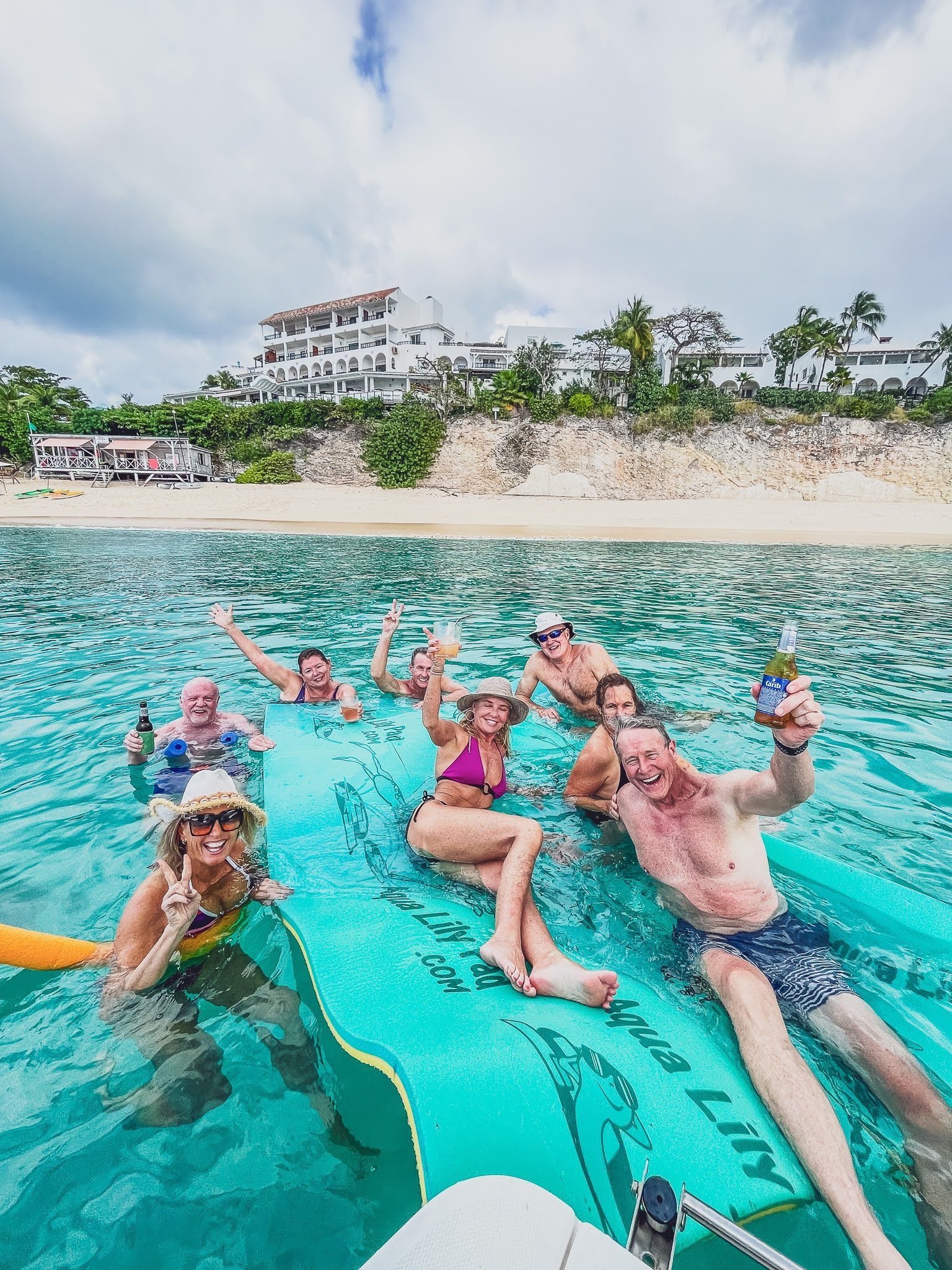 A group of people are floating on a raft in the ocean.