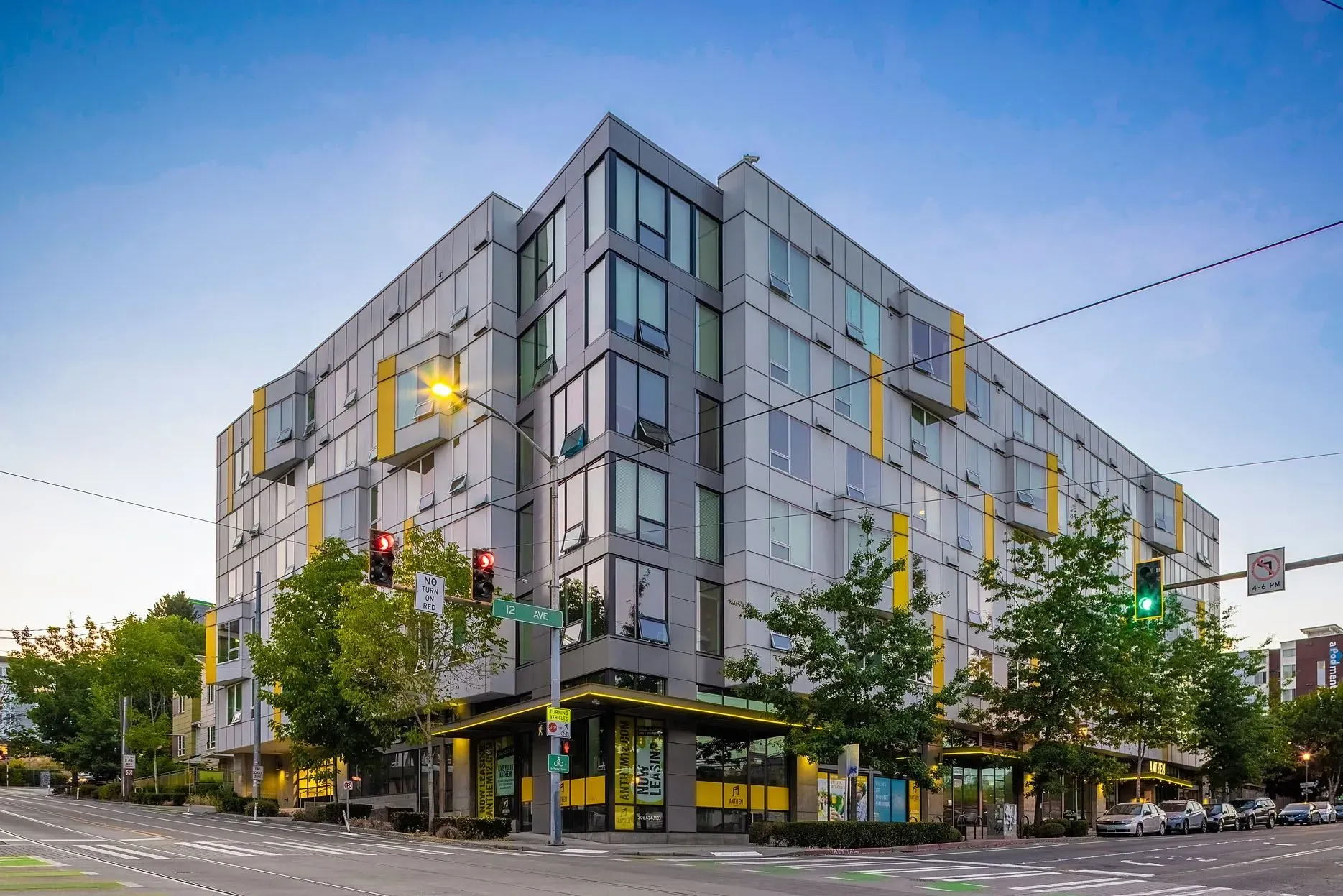 Modern apartment building exterior with contemporary design and yellow accents.