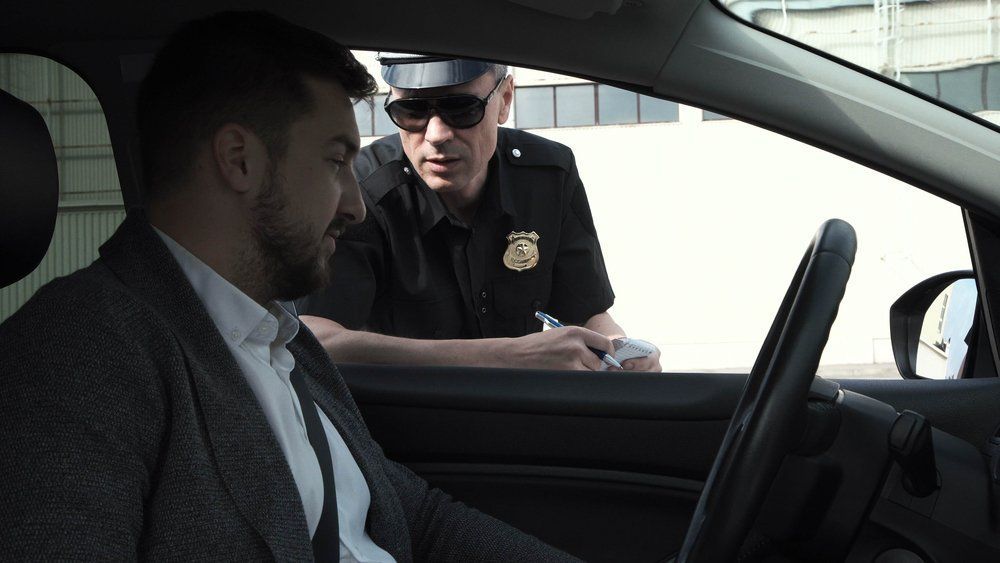 Police officer speaking to driver through car window