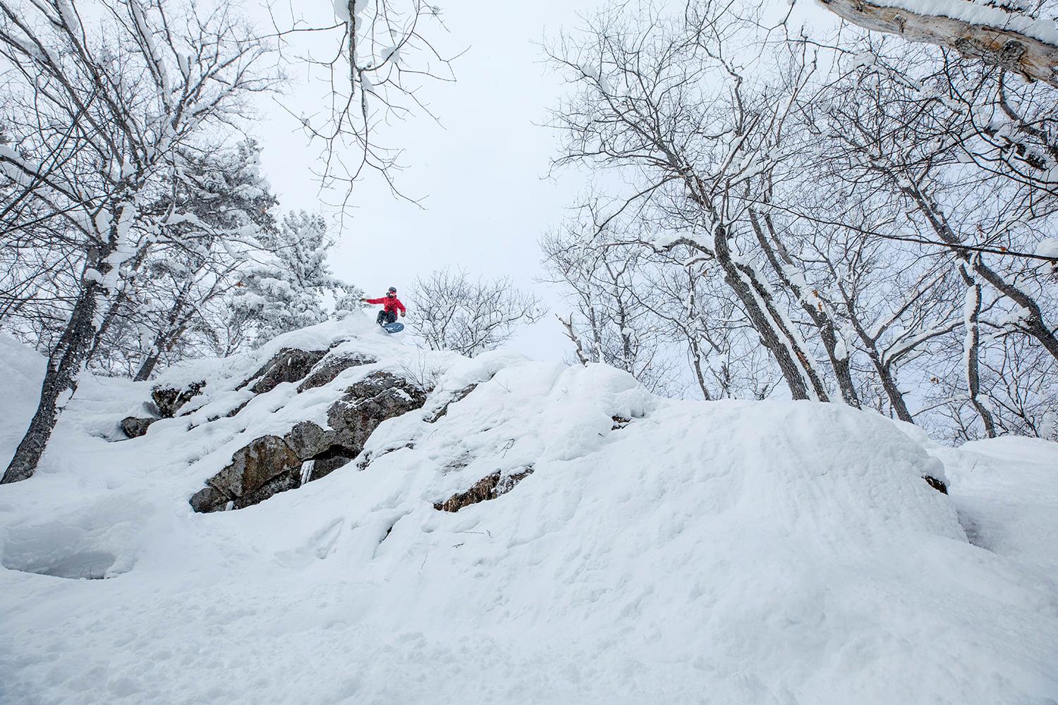 A person is skiing down a snow covered mountain at Mt. Bohemia