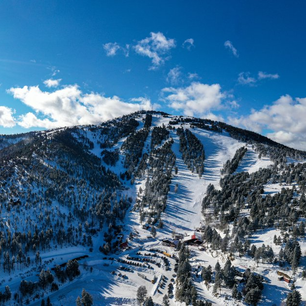 An aerial view of a Great Divide  mountain covered in trees.