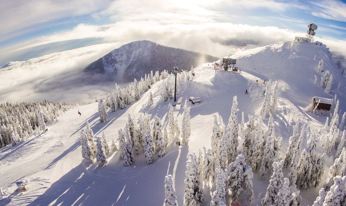 An aerial view of Red Mountain with trees covered in snow.