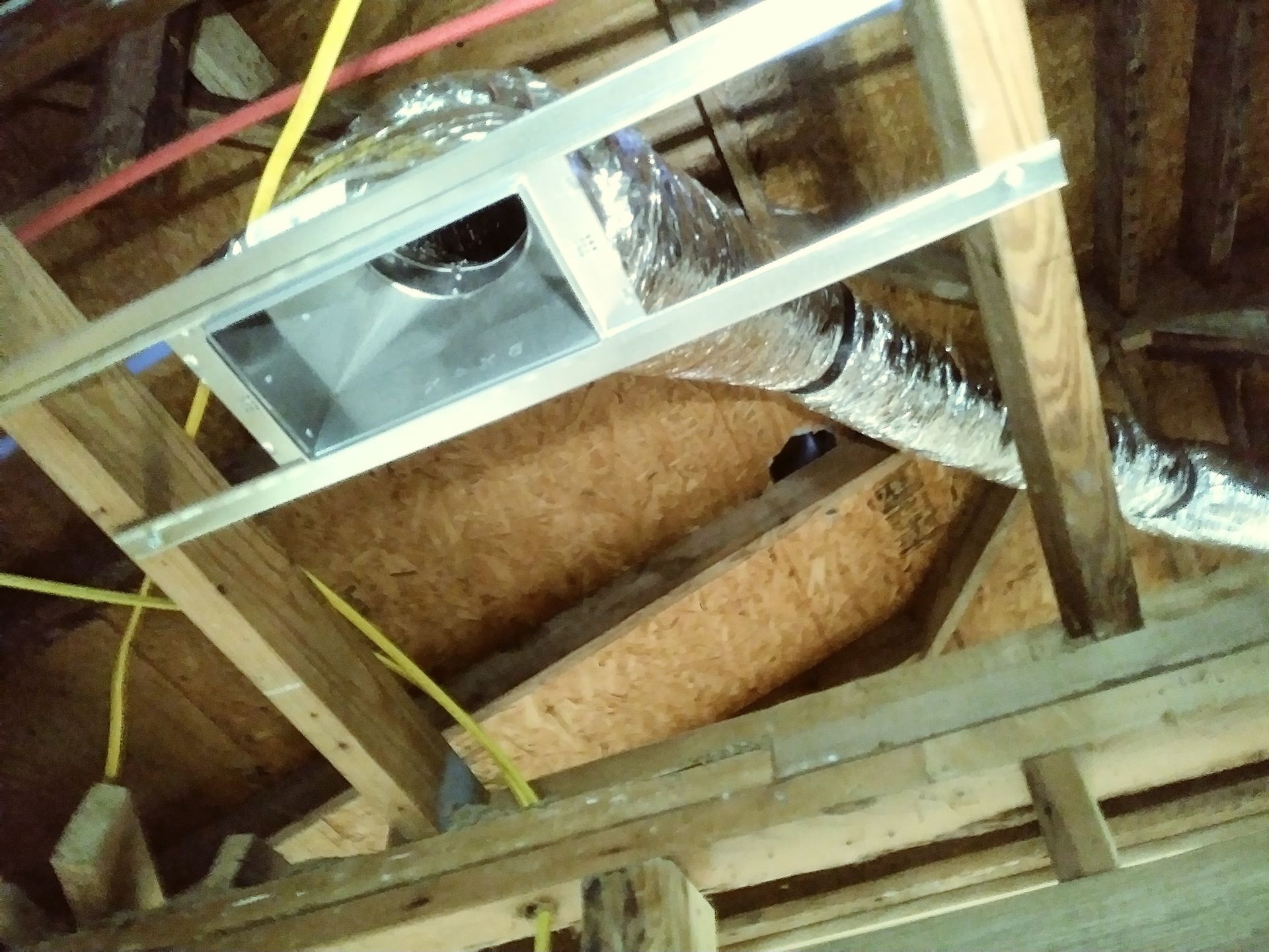a wooden ceiling with a metal pipe coming out of it .