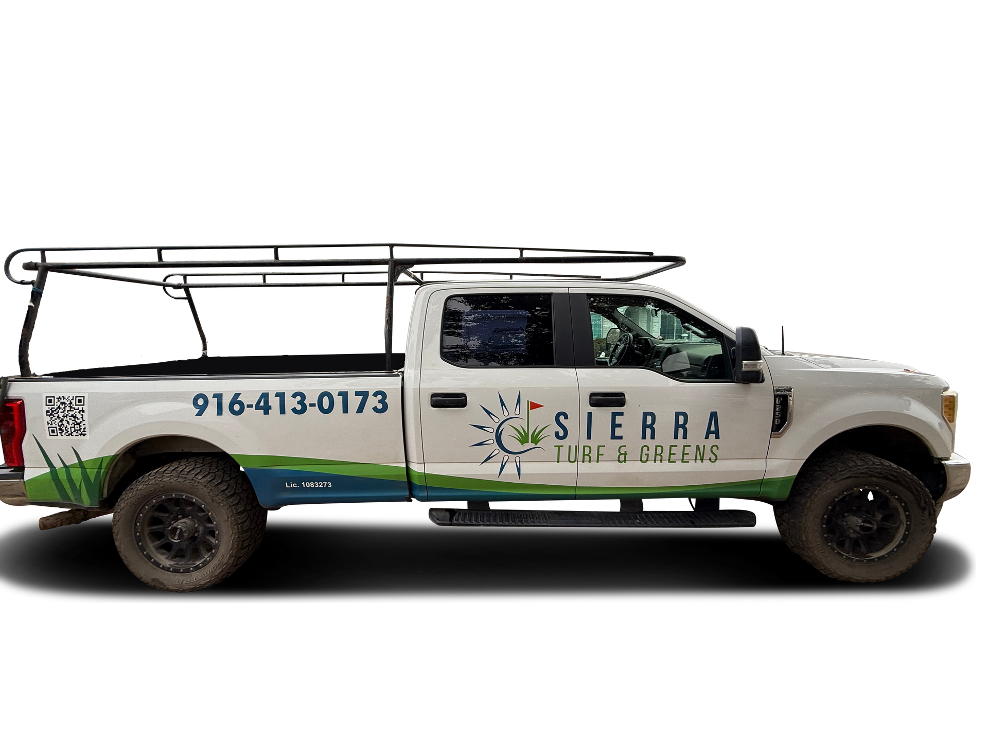 White Sierra Turf & Greens truck with equipment rack and green/blue graphics, parked.