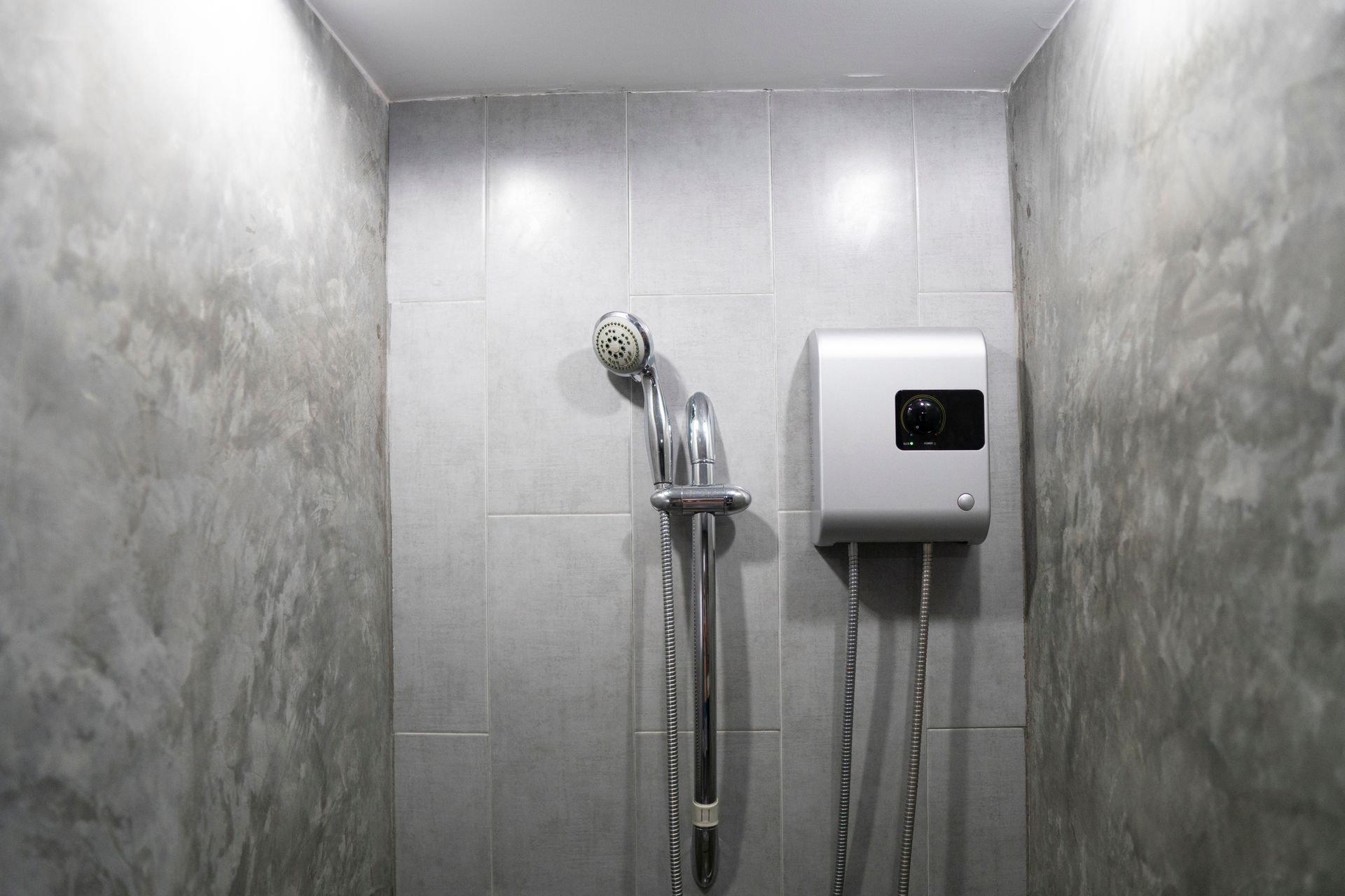 Modern bathroom with shower head and water heater installed by trusted Plumber In Cuyahoga Falls professionals.