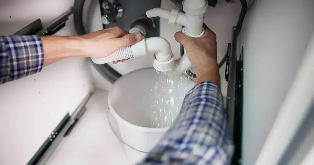 Technician fixing a water heater in a bathroom, delivering professional Plumbing services in Copley for homeowners.