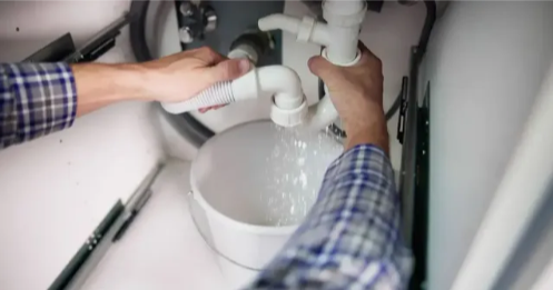 Plumber in Cuyahoga Falls from Unique Plumbing & Drain, Inc., repairing a leaking sink pipe