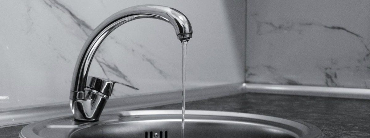 Kitchen plumbing in Copley: chrome faucet into stainless sink, Unique Plumbing & Drain