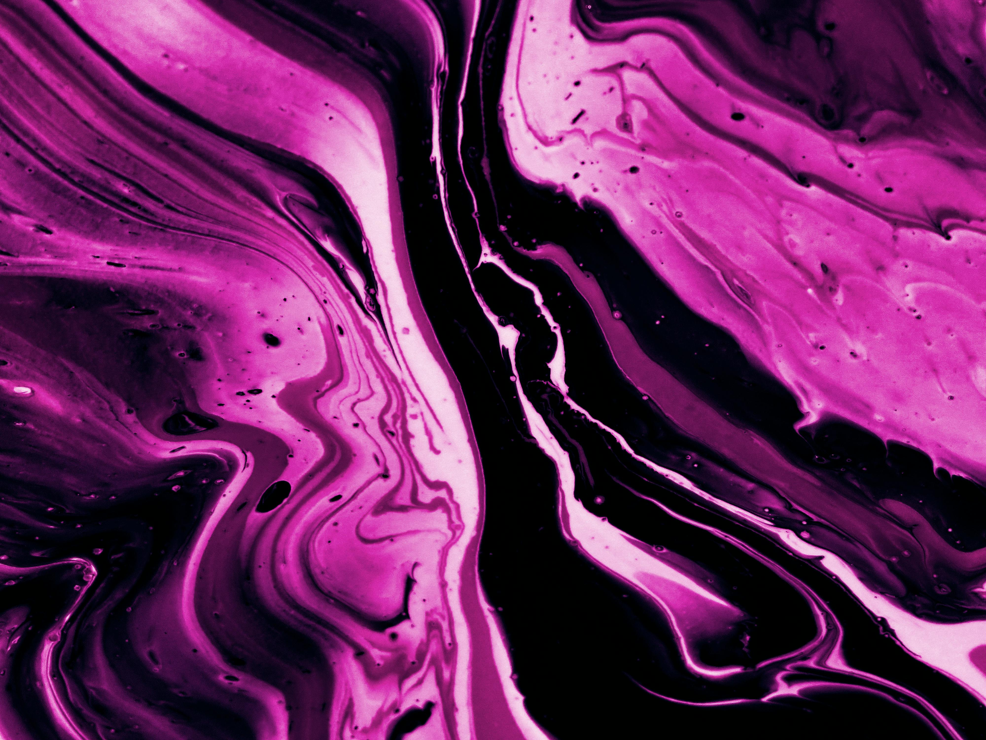 A close up of a purple and black marble texture.