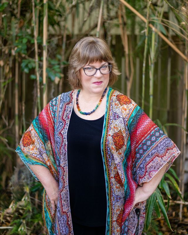 Missy Barnes in a colorful kimono, portrait against greenery