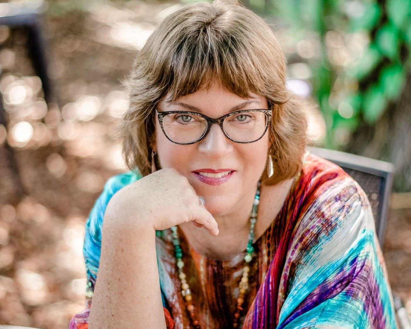 Missy Barnes, close-up portrait, smiling, wearing glasses