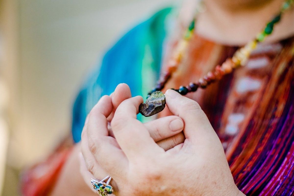 Missy Barnes holding a crystal in her hands, close-up