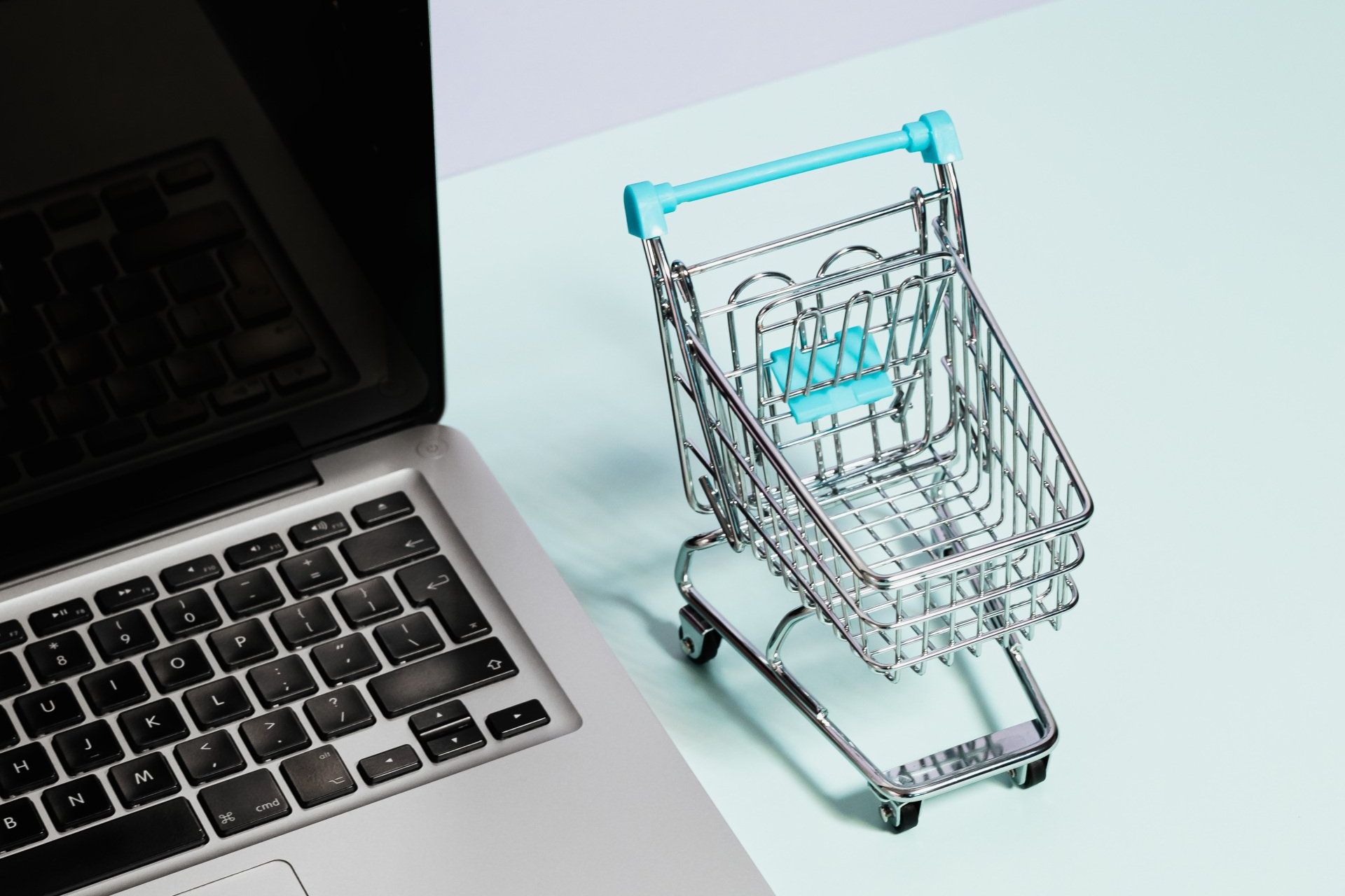 A Laptop with a Small Shopping Cart at Overseas Filipino Workers An image of a laptop with a small shopping cart at Overseas Filipino Workers