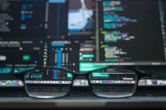An image of an eyeglass Infront of a computer screen showing data at Overseas Filipino Workers