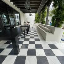 A black and white checkered floor with a table and benches.