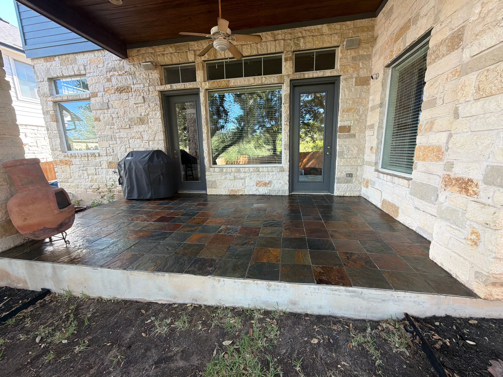 A large brick house with a wagon wheel in front of it