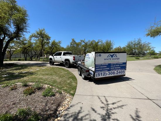 A truck is towing a trailer with a tank on it.