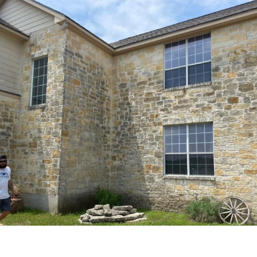 A man standing in front of a large stone building