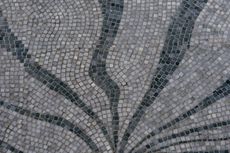 A close up of a mosaic with a circular pattern