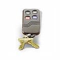 Key fob with four buttons attached to two golden keys.