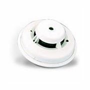 White, circular smoke detector mounted on a ceiling.
