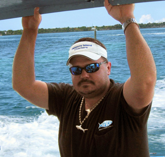 A man wearing a hat that says treasure island fishing