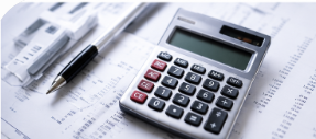 Calculator and pen on financial paperwork, with charts and documents in the background