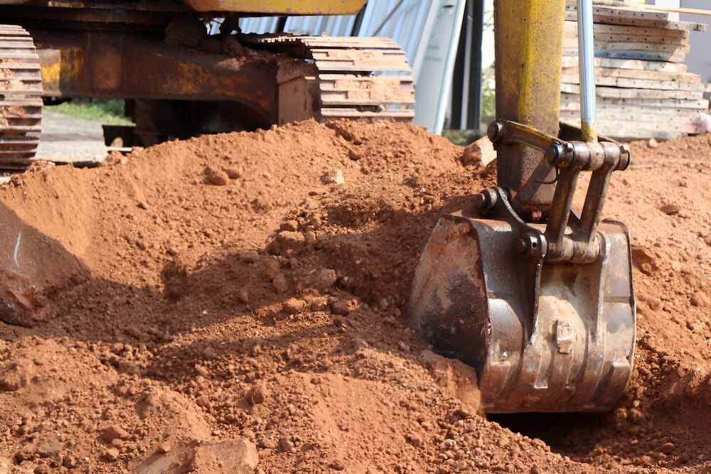 A Bulldozer Is Digging A Hole In The Ground — Jeff Thompson Excavator Hire Pty Ltd In Pink Lily, QLD