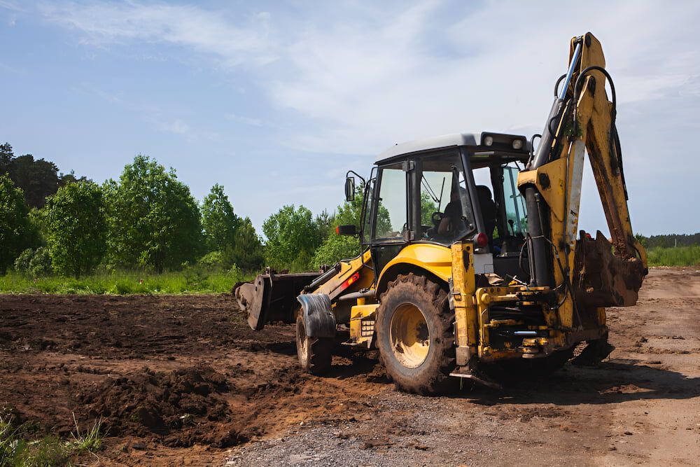 A Yellow Excavator Is Sitting On The Side Of A Dirt Road — Jeff Thompson Excavator Hire Pty Ltd In Pink Lily, QLD