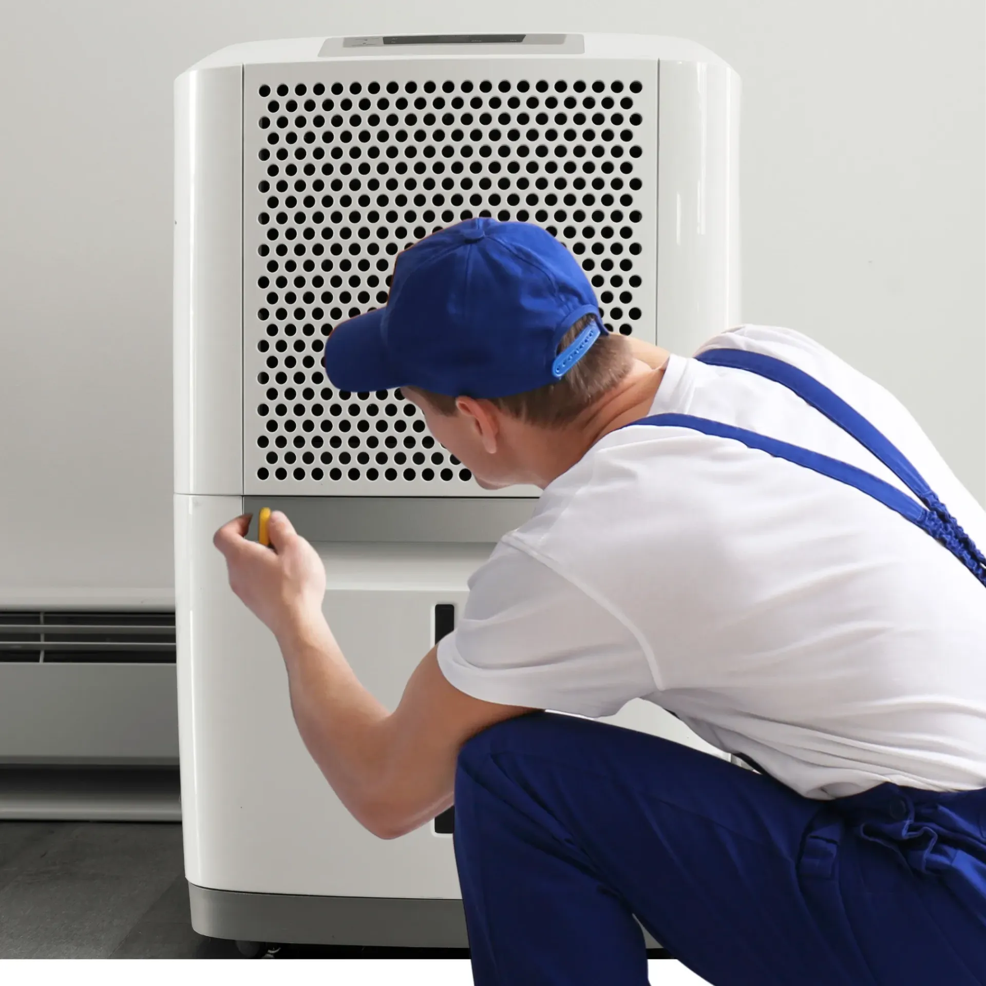 Comfort Air Solution LLC - A man wearing a blue hat is working on a machine