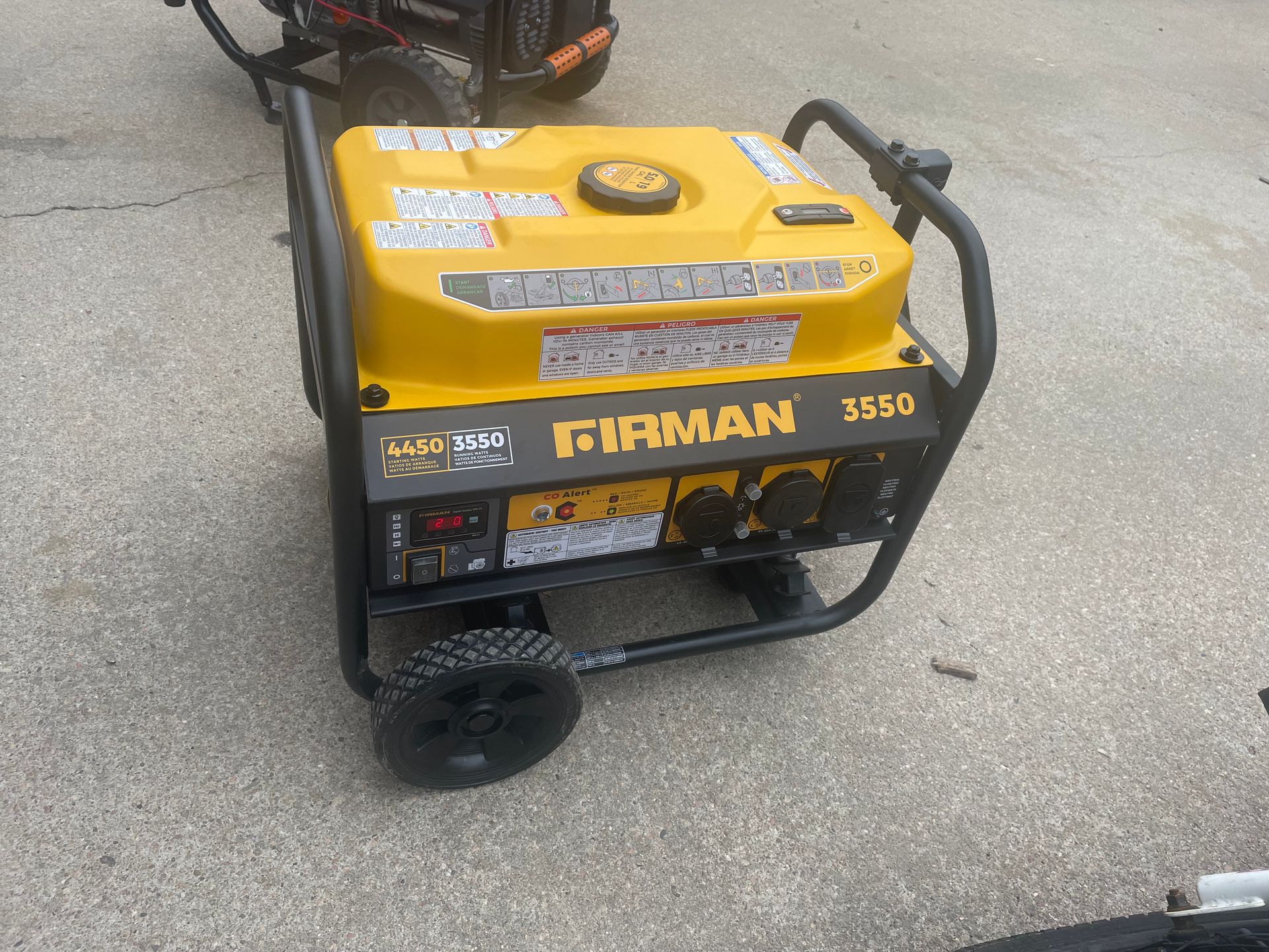 A yellow and black firman generator is sitting on the ground